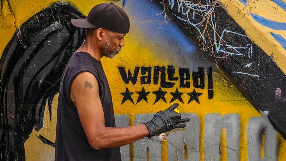 Artist SparkyZ, whose real name is Zack White, shows off his latest mural paying homage to the Grand Theft Auto series and the city of Atlanta at the Krog Street Tunnel on July 9, 2024.