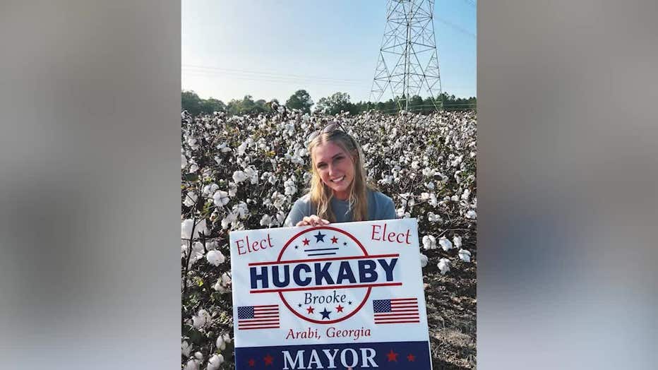 Brooke Huckaby, 21, holds her election sign in her bid to become mayor for Arabi, Georgia.