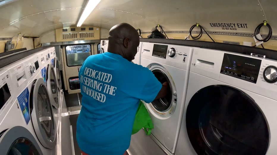 Nicky Crawford, founder of Flowing with Blessings, works inside a converted us that now houses washers and dryers to aid the homeless population in Atlanta.