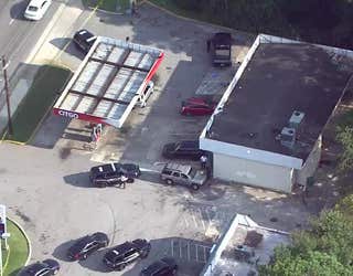 Police investigate a shooting at a gas station along Columbia Drive near I-20 in DeKalb County on Aug. 13, 2024.