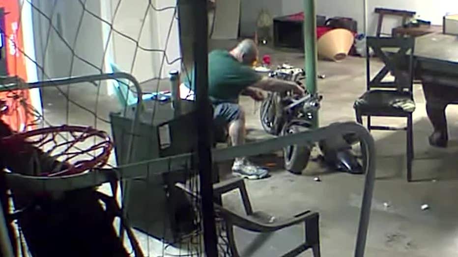 This image shows Michael Coppeak’s typical setup while working on his motorcycle inside his garage at his Cobb County home.