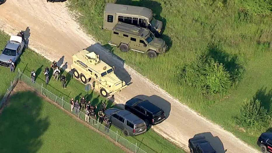 Law enforcement officials swarm the area of Old Jones Road and Acorn Creek Road in Whitesburg searching for a man who fired at deputies on Aug. 22, 2024.