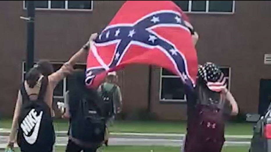 This image from video provided to FOX 5 shows students on the campus of Coosa High School displaying a Confederate battle flag in 2021.