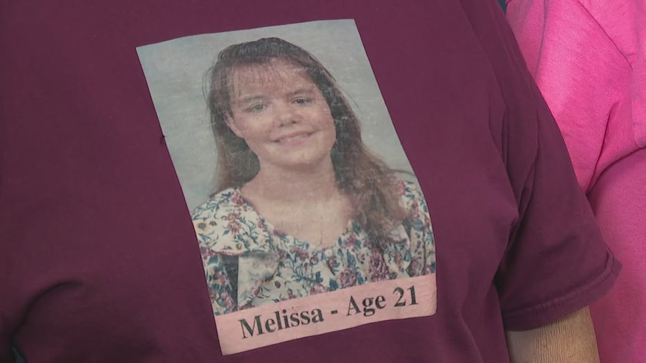 A family member of Melissa Wolfenbarger wears a T-shirt to honor the 21-year-old, who was killed in 1999, during a press conference announcing an arrest in Atlanta on Aug. 7, 2024.