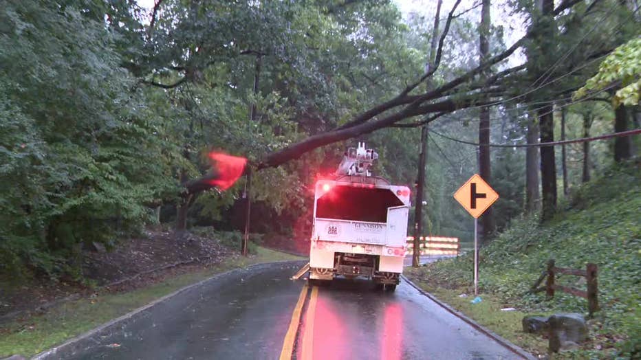 Crews work to clear a fallen tree along Powers Ferry Road in Sandy Springs on Sept. 26, 2024
