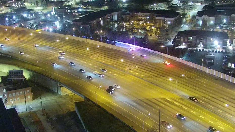 This image shows a line of police officer accompanying an ambulance with an injured officer inside through the Downtown Connector en route to Grady Memorial Hospital on Feb. 25, 2025.