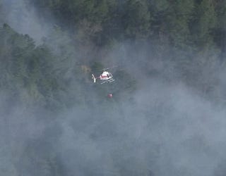 Fire crews are battling a wildfire along Cartersville Highway near Rome on March 25, 2025.