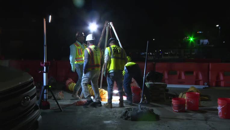 Crews work to repair a sinkhole along North Avenue near Tech Parkway in Atlanta on March 25, 2025.