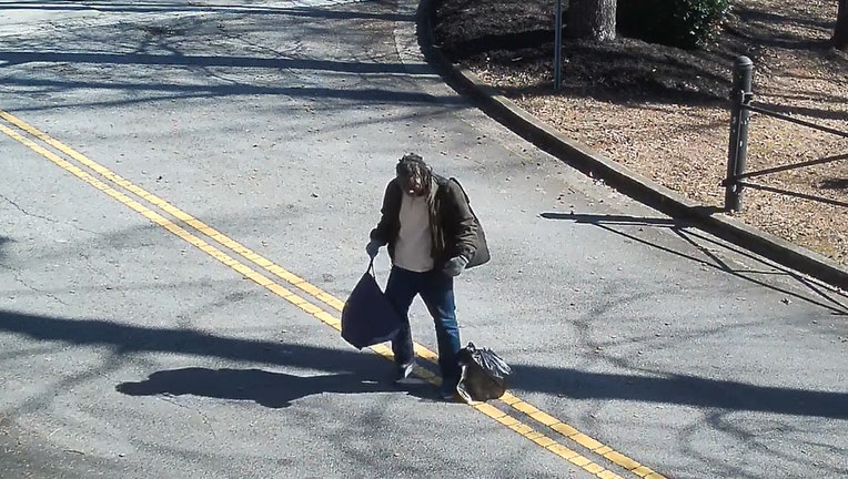 This image released through Crime Stoppers Greater Atlanta shows a man leaving bodily fluids on the property of the Solid Rock Pentecostal Church along Washington Road in South Fulton, according to investigators.