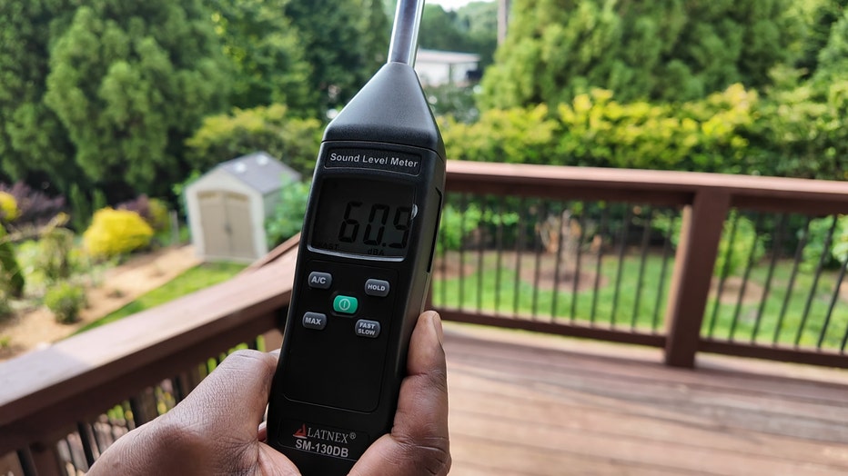 Andre Jackson holds his decibel meter, which reads above 60 as he’s standing on a deck more than 200 feet away from Brock Shorter’s pool on Sunday. (FOX 5)