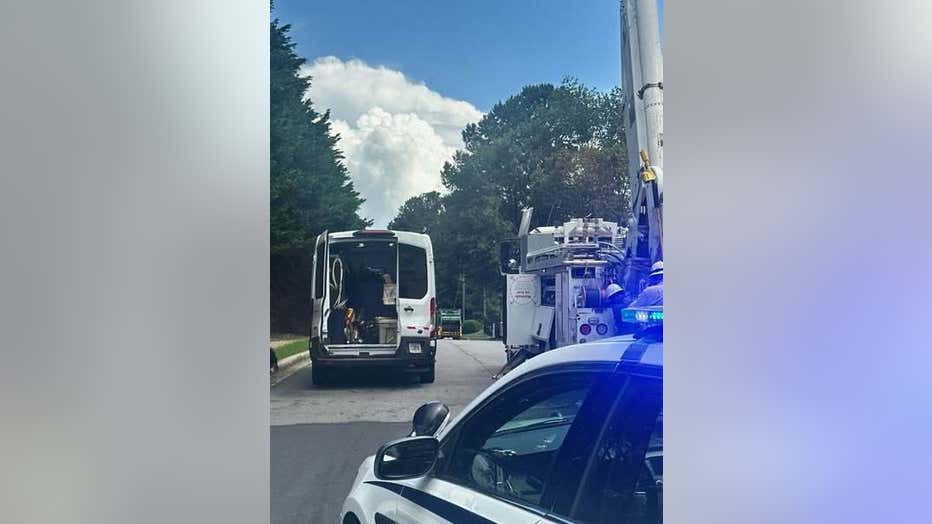 Power lines fall on a garbage truck along Castleberry Drive at Chatham Road in Gwinnett County on June 10, 2025.