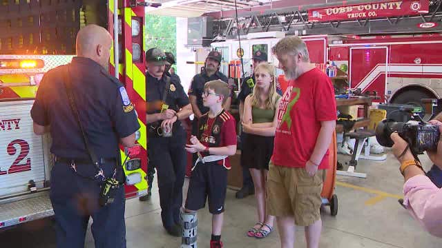 Cobb County boy meets firefighters who helped save him after crash