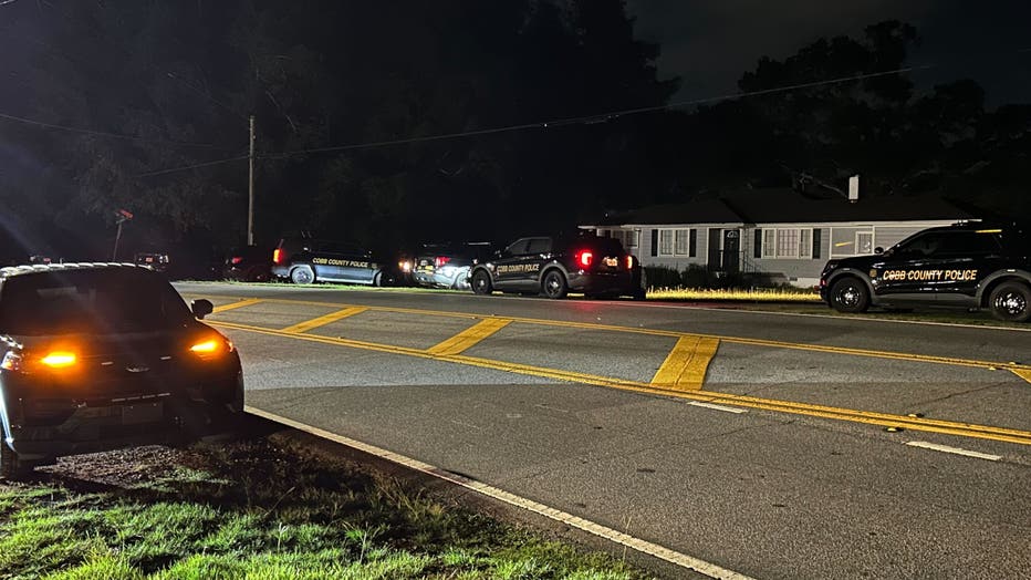 Law enforcement officials surround the scene of an officer-involved shooting and SWAT standoff along Eugenia Place off Austell Powder Springs Road in Cobb County on July 31, 2025.