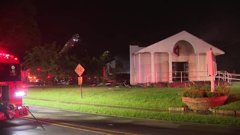 Firefighters work to hit hot spots after a lightning strike sparked a fire at the Redan United Methodist Church located along S. Stone Mountain Lithonia Road in Lithonia on July 1, 2025.