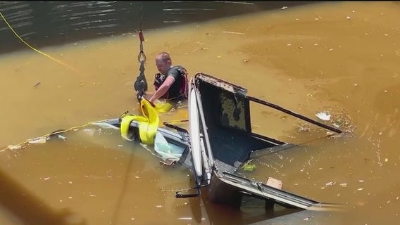 Firefighter dives into water to try save driver from submerged truck