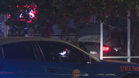 Car slams into Avis building during police chase