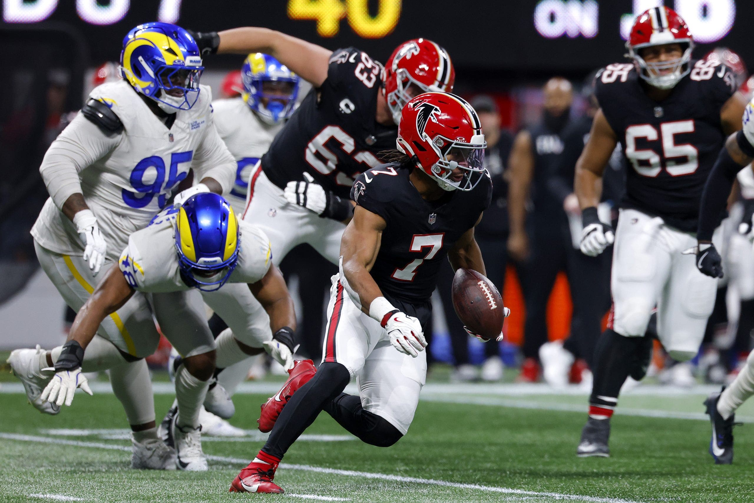 Falcons survive late scare, upset Rams 27-24 on Robinson’s record run