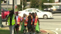 Volunteers clean up Old National Highway ahead of block party