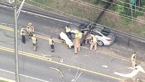 Video: Crews rescue man whose vehicle was trapped under a utility pole