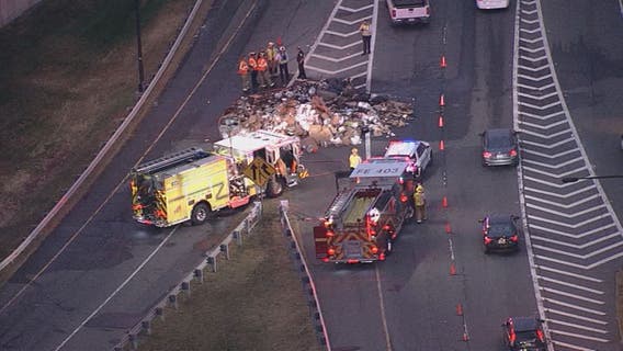 Trash truck fire spreads garbage along westbound lanes of the Dulles Access Road causing delays