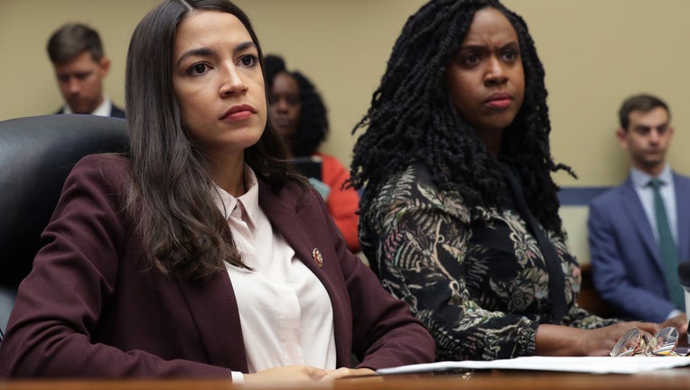 WASHINGTON, DC - JULY 26: House Oversight and Government Reform Committee members Rep. Alexandria Ocasio-Cortez (D-NY) (L) and Rep. Ayanna Pressley (D-MA) attend a hearing on drug pricing in the Rayburn House Office building on Capitol Hill July 26, 2019 in Washington, DC. As members of a group of four freshman Democratic women of color, known informally as 'The Squad,' the congresswomen heard testimony from patients and their family members about the negative impacts of rising drug prices in the United States. (Photo by Chip Somodevilla/Getty Images)