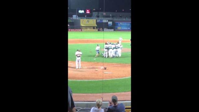 Pitcher embraces batter after game-ending strikeout in Minnesota high school playoffs