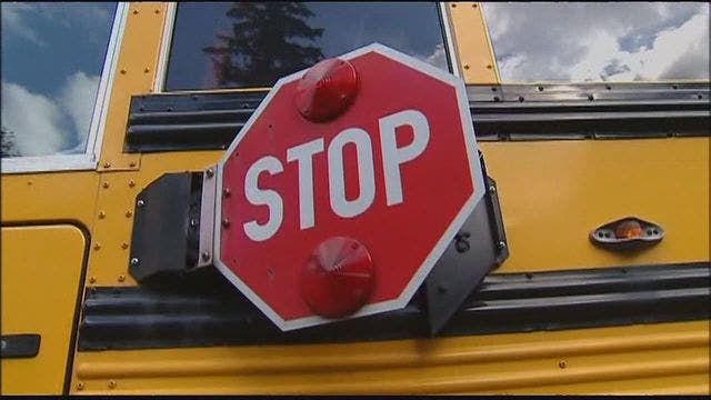 Boy hit by car after driver ignores school bus stop sign, lights