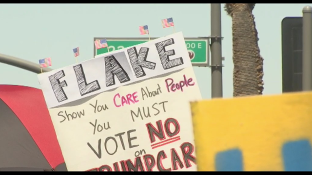 Demonstrators protest outside McCain and Flake's offices before vote on AHCA bill
