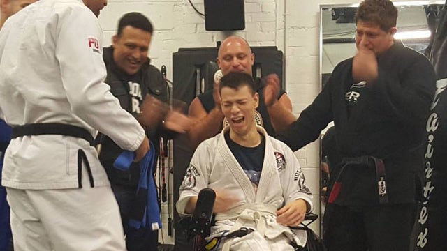 Man with cerebral palsy and cancer receives blue belt in jiu-jitsu