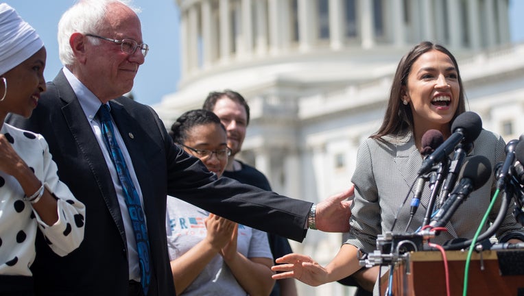 Representative Alexandria Ocasio-Cortez (2nd R), Democrat of New York, speaks alongside US Senator Bernie Sanders (2nd L), Independent of Vermont, and Representative Ilhan Omar (L), Democrat of Minnesota, during a press conference to introduce college affordability legislation outside the US Capitol in Washington, DC, June 24, 2019. (Photo by SAUL LOEB / AFP) (Photo credit should read SAUL LOEB/AFP/Getty Images)