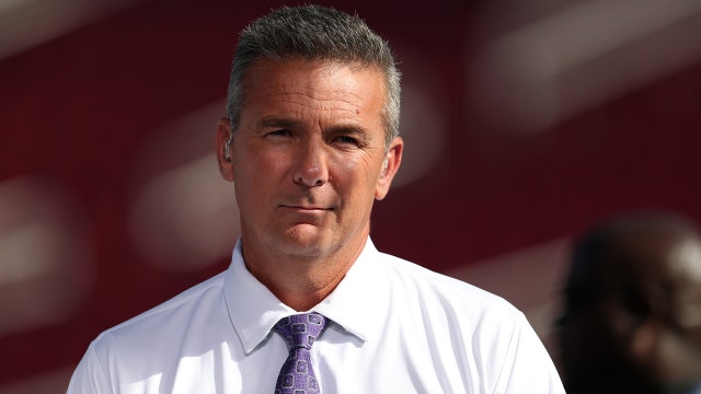 Urban Meyer watching Sunday's Redskins game from Dan Snyder's box