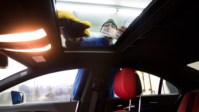 SCARBOROUGH, ME - MARCH 15: Donnie Parker details a vehicle in Scarborough on Tuesday, March 15, 2016. Parker cleans the sunroof on a Mercedes CLS550 Coupe. (Photo by Derek Davis/Portland Portland Press Herald via Getty Images)