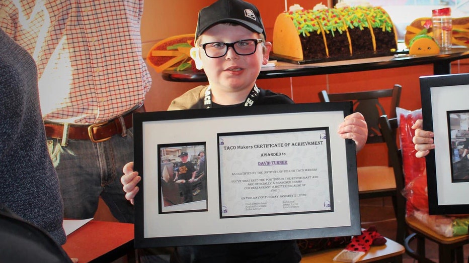 8-year-old David awarded best Taco Maker certificate during honorary employment at Taco Ball.
