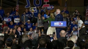 Women holding 'let dairy die' signs storm stage at Biden Super Tuesday event