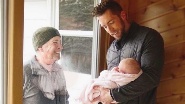 This grandfather walks four miles to see his newborn granddaughter through a glass door.