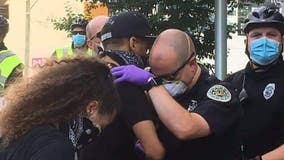 Police officer prays with protester in 'touching' photo