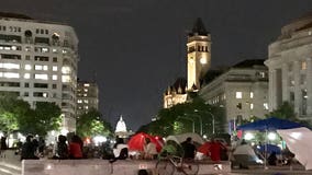 Demonstrators stage a sit-in outside Wilson Building after DC police hearing