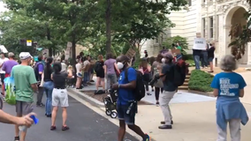 Protesters rally outside Postmaster General's home with "wake-up call" for him to resign