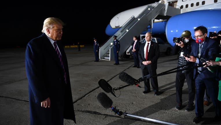 President Donald Trump speaks to the media as he reacts to the news of the death of US Supreme Court Justice Ruth Bader Ginsburg on the tarmac of Bemidji Regional Airport after addressing supporters during a 