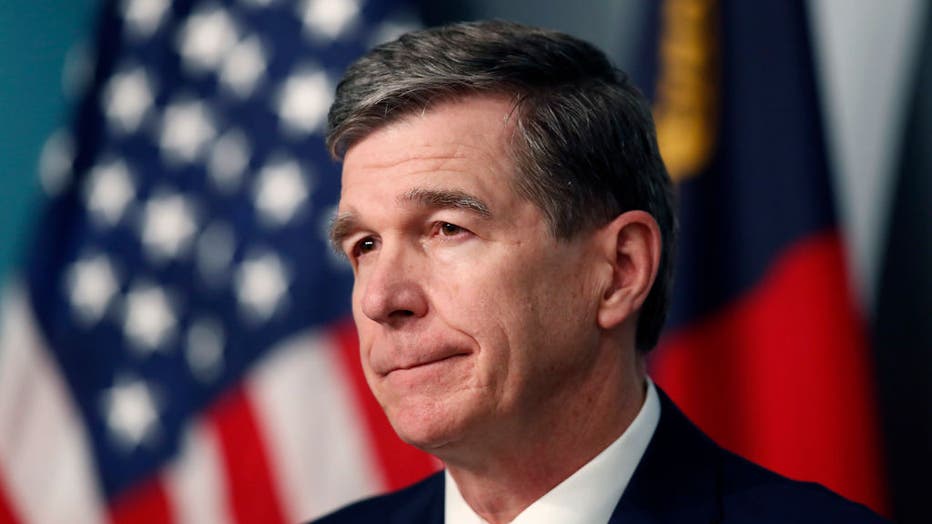FILE - North Carolina Gov. Roy Cooper listens to a question during a briefing on the coronavirus pandemic at the Emergency Operations Center in Raleigh, N.C., Tuesday, May 26, 2020.