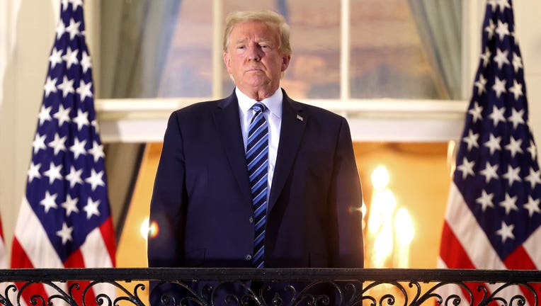 President Donald Trump stands on the Truman Balcony after returning to the White House from Walter Reed National Military Medical Center on Oct. 5, 2020 in Washington, D.C. Trump spent three days hospitalized for COVID-19. (Photo by Win McNamee/Getty Images)