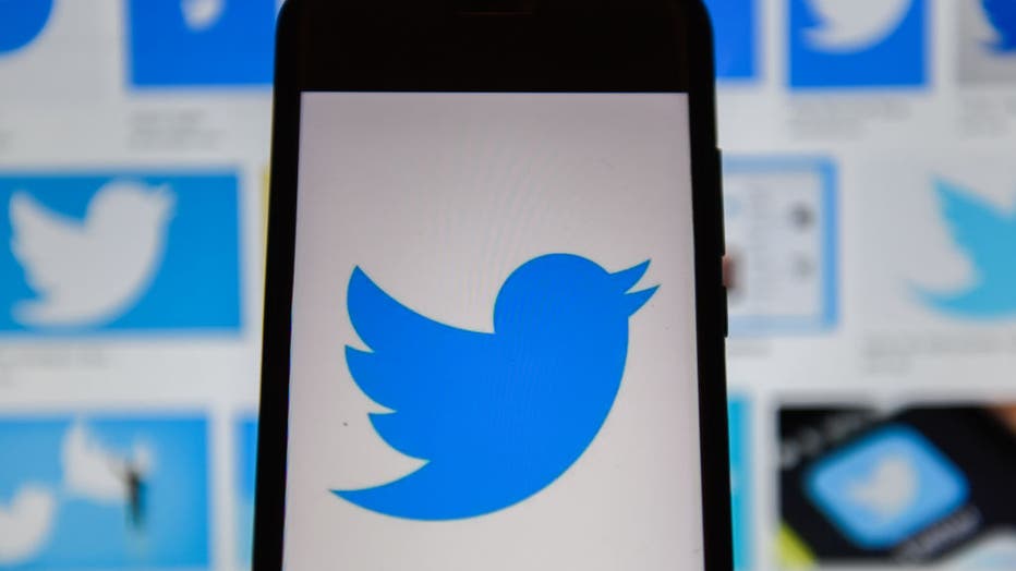 In this photo illustration a Twitter logo seen displayed on