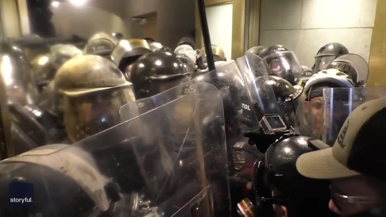 Police officer crushed in door as Trump loyalists storm US Capitol