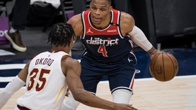 Wizards' Russell Westbrook has popcorn dumped on him as he walks to locker room