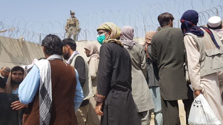 People continue to wait at Kabul's Hamid Karzai Airport