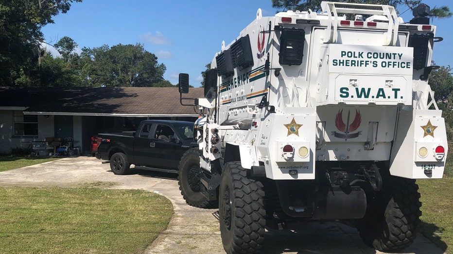 PCSO-SWAT-vehicle-in-front-of-residence-and-suspect-vehicle.jpg