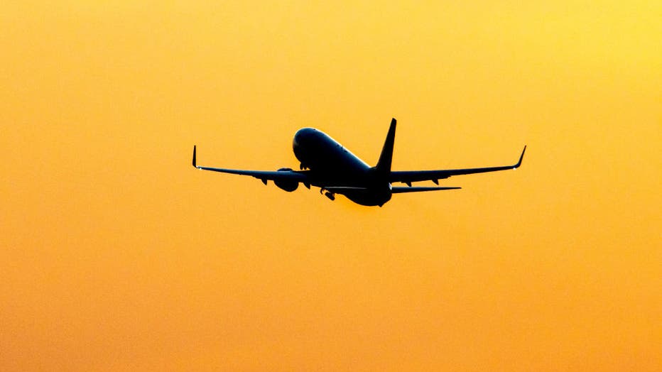 Silhouette Of A Departing Aircraft During Sunset