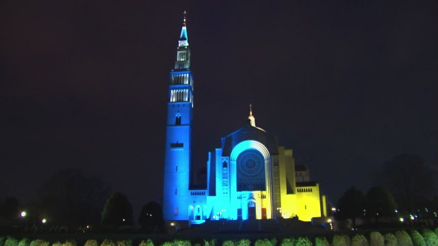 DC’s Basilica of the National Shrine glows blue and yellow in support of Ukraine