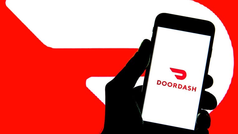 In this photo illustration, a DoorDash logo seen displayed