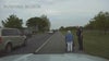 Watch: Officer escorts elderly woman walking along busy highway to hair salon
